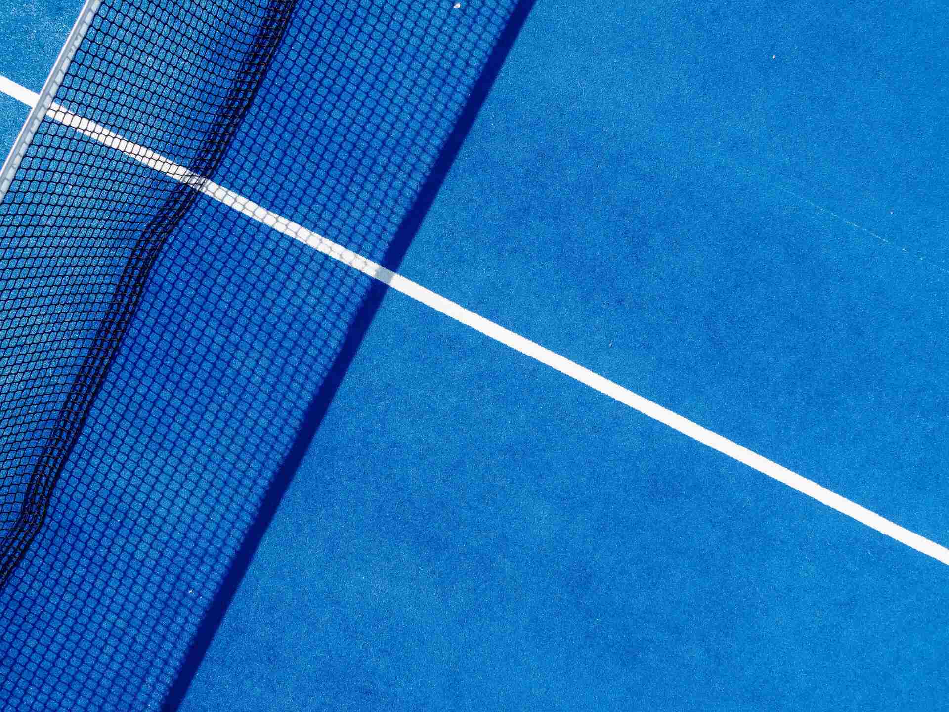 aerial view of the service boxes and net of a blue tennis court